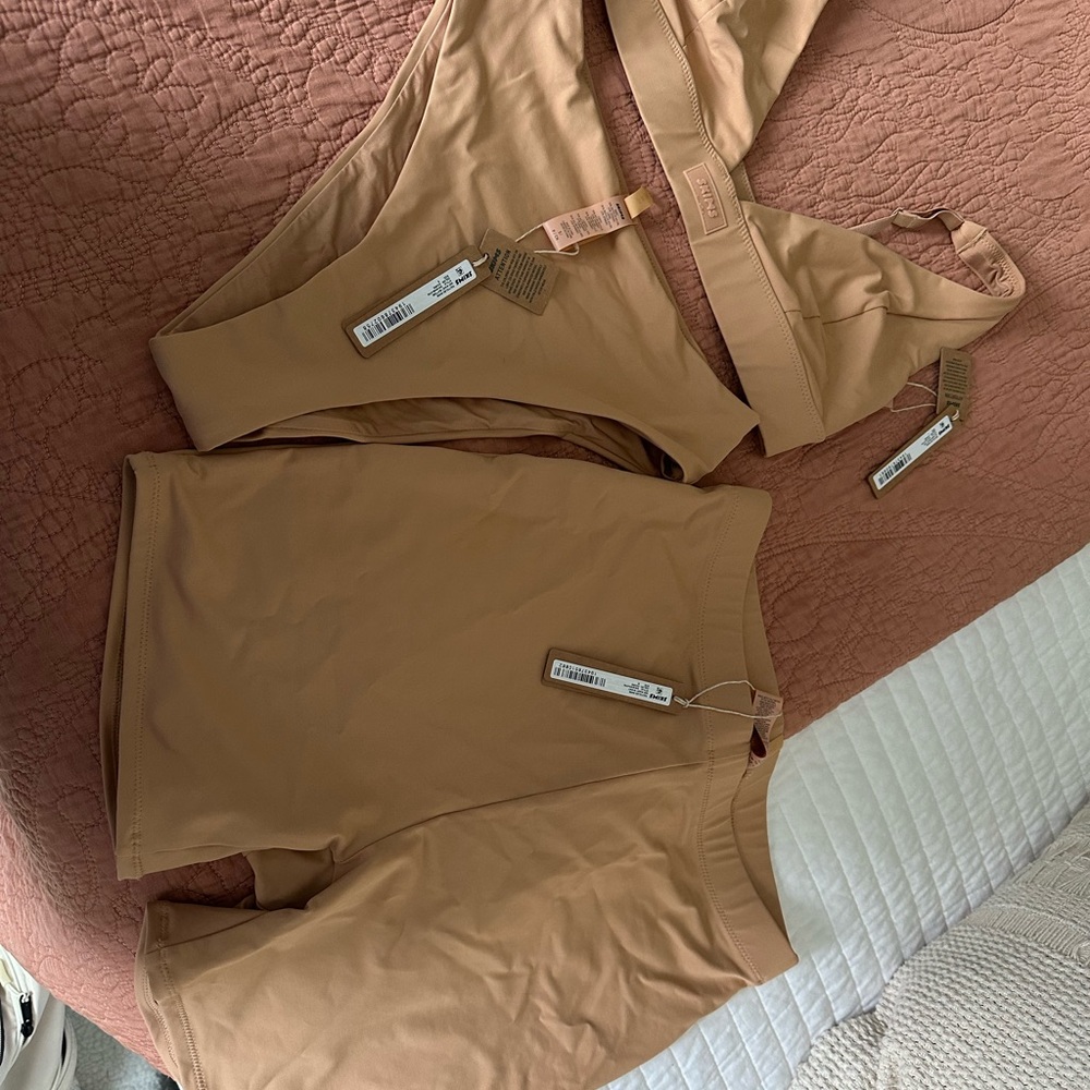 SKIMS Cream Seamless bikini and swim shorts